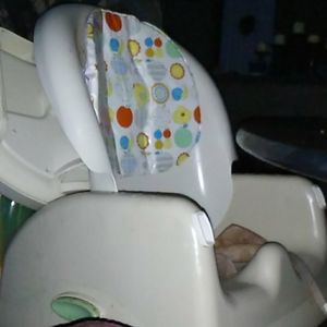 A high chair that buckles up to a regular chair